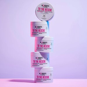 5 Noughty haircare To the Rescue intense moisture treatment balanced on top of each other. Photographed and styled by cosmetic photographer Tom Hargreaves in his studio in Exeter, Devon
