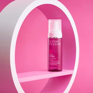 Superfacialists rosehip hydrate gentle foaming cleanser framed within a circular white and pink prop on a baby pink background. A cosmetic styled product photograph shot in Tom Hargreaves studio in Exeter Devon