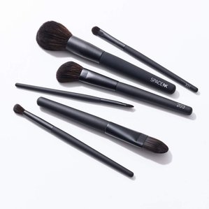 Photograph of SpaceNK brushes lying on white background. Photographed and styled by cosmetic photographer Tom Hargreaves in his studio in Exeter, Devon