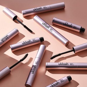 multiple Uklash volume boost mascaras lying in ray of light. Photographed and styled by cosmetic photographer Tom Hargreaves in his studio in Exeter, Devon