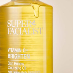 Close up of Superfacialist Vitamin C cleansing oil bottle with oil dripping down the bottle. Photographed and styled by cosmetic photographer Tom Hargreaves in his studio in Exeter, Devon