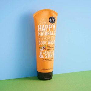 Happy Naturals nourishing body wash with argan oil and shea on a blue and green background. Photographed and styled by cosmetic photographer Tom Hargreaves in his studio in Exeter, Devon