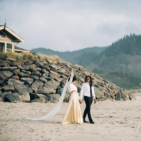 The bride lifts the bottle of champagne victoriously