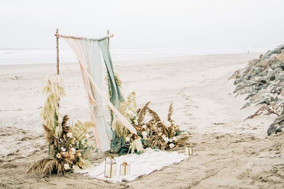 An elaborate arch awaits the couple on the beach, ready for their elopement ceremony