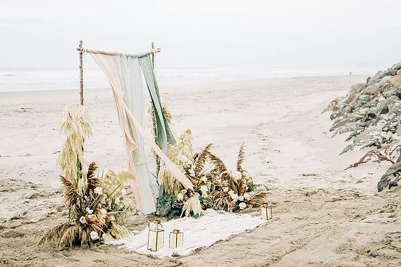 An elaborate arch awaits the couple on the beach, ready for their elopement ceremony