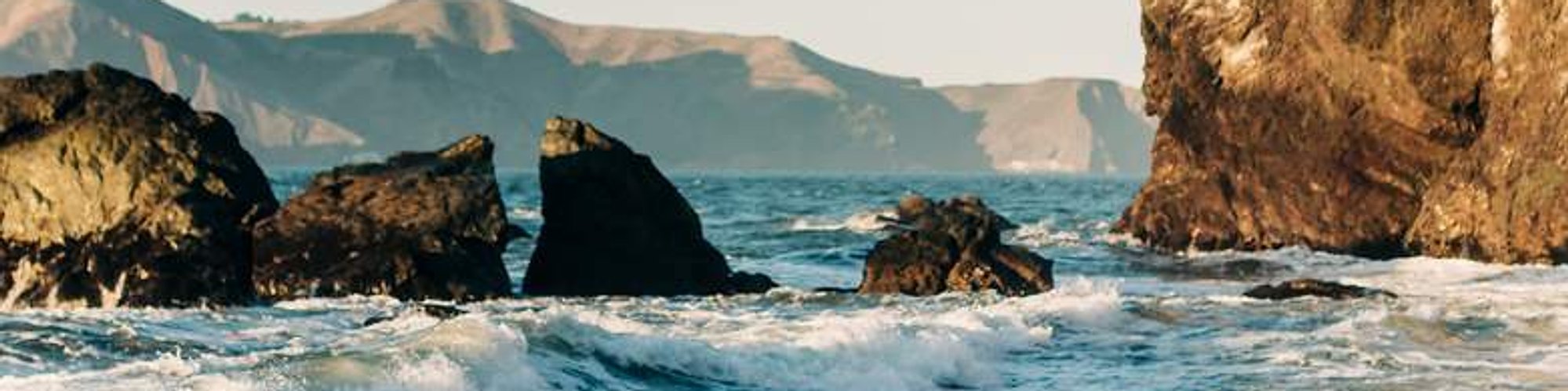 Waves crash against the rocks on a San Francisco beach