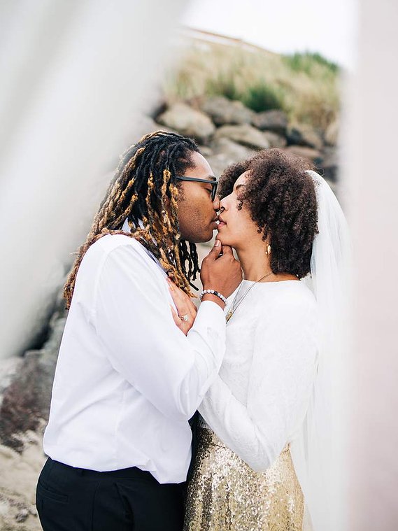A bride and groom during their elopement ceremony, leaning in for a kiss