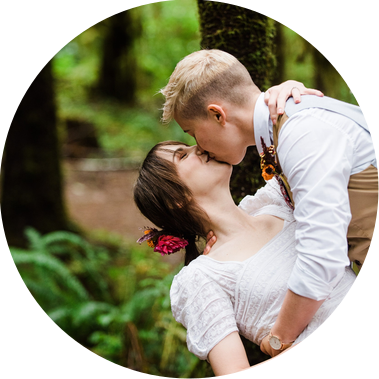 A groom dips his bride backwards into an enthusiastic kiss after their elopement ceremony