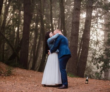 A bride and groom stop for an impromptu dance in the forest as they hike back to the trailhead from their elopement location