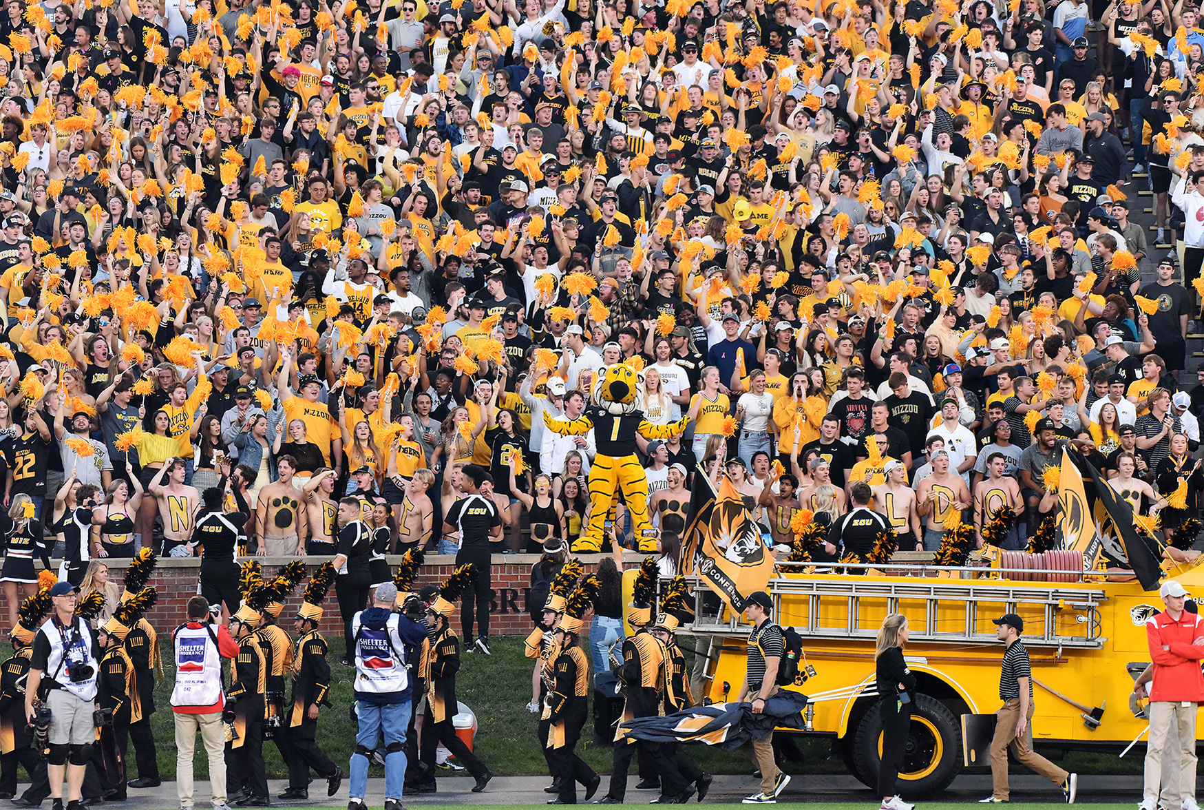 The University of Missouri school mascot stands in front of a cheering student section at a football game against Georgia.