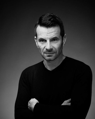 Black and white corporate portrait of a man, taken in studio