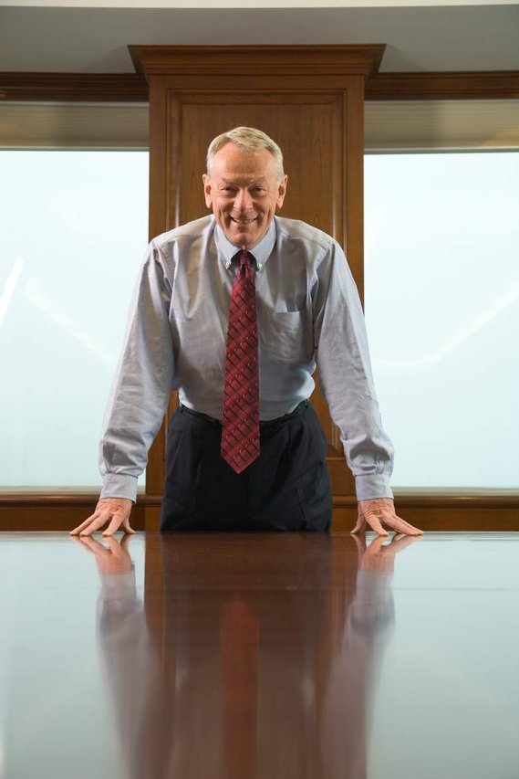 Portrait of an executive leaning over a conference room large table
