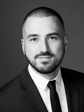 Individual corporate portrait of young man, in black and white 