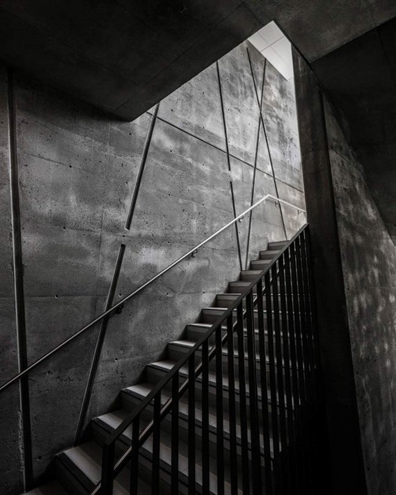 Black and white photo of a concrete staircase in a school