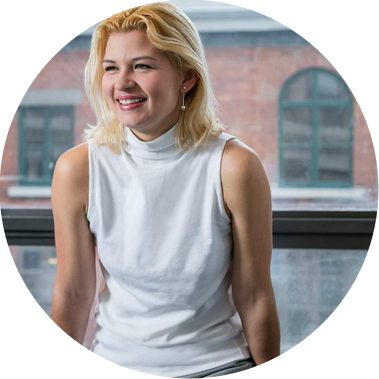 Corporate portrait of a young woman posing in front of a window  at an Architect firm's offices