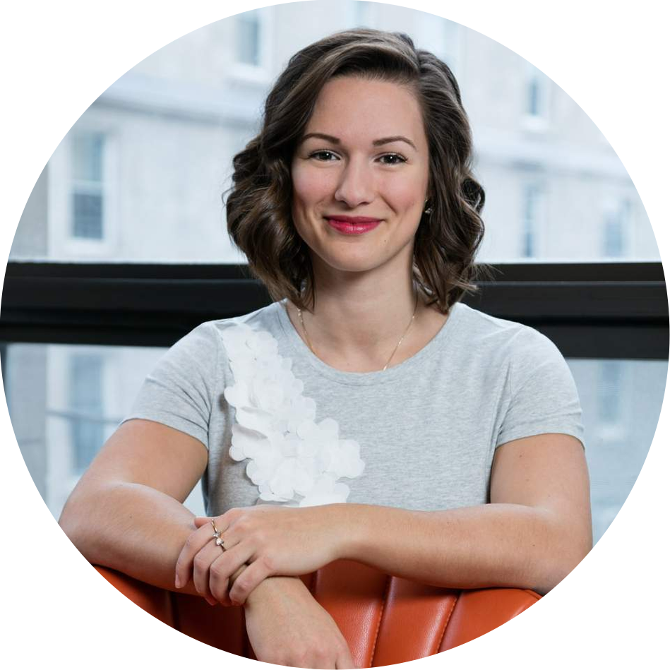 Corporate portrait of a young woman posing in front of a window  at an Architect firm's offices