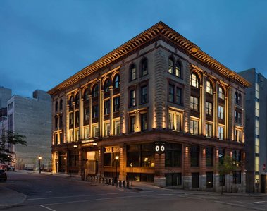 Exterior architecture night photo of the old LaPresse building at 7 rue Saint-Jacques west, in Montreal