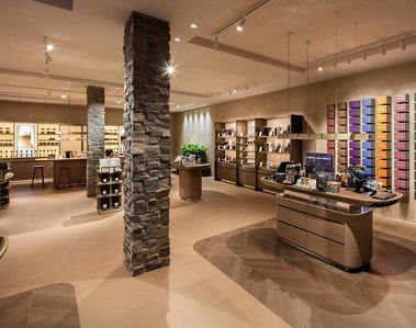  Boutique Nespresso à Québec, mettent en valeur son aménagement typique avec murs de pierres, grands présentoirs de produits et ilots pour les caisses