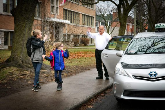Taxi cab dropping kids at school