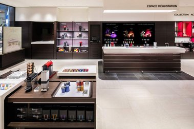 Boutique Nespresso à Québec avec comptoir au premier plan et étagère exhibant de nombreux produits