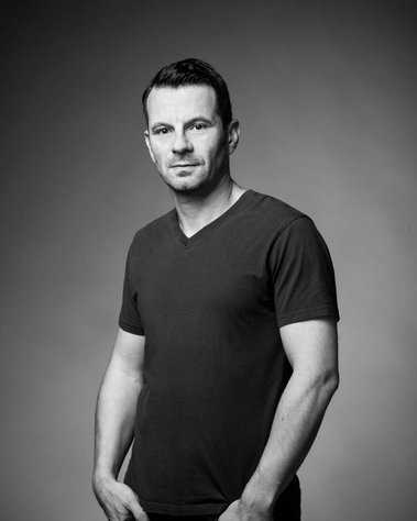 Black and white corporate portrait of a man, taken in studio