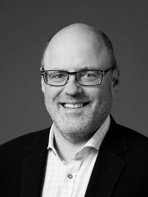 Individual corporate portrait of  man, in black and white 
