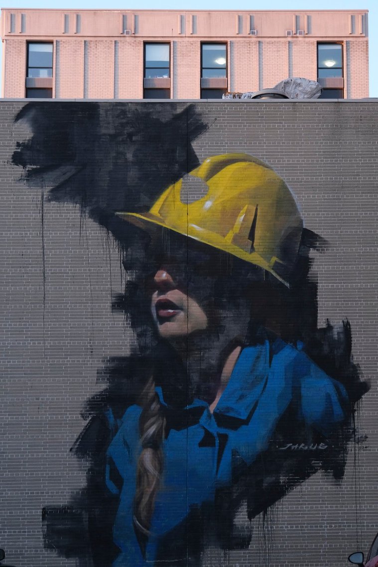 Art Mural of a woman miner wearing a helmet in Larch St. Sudbury. 
