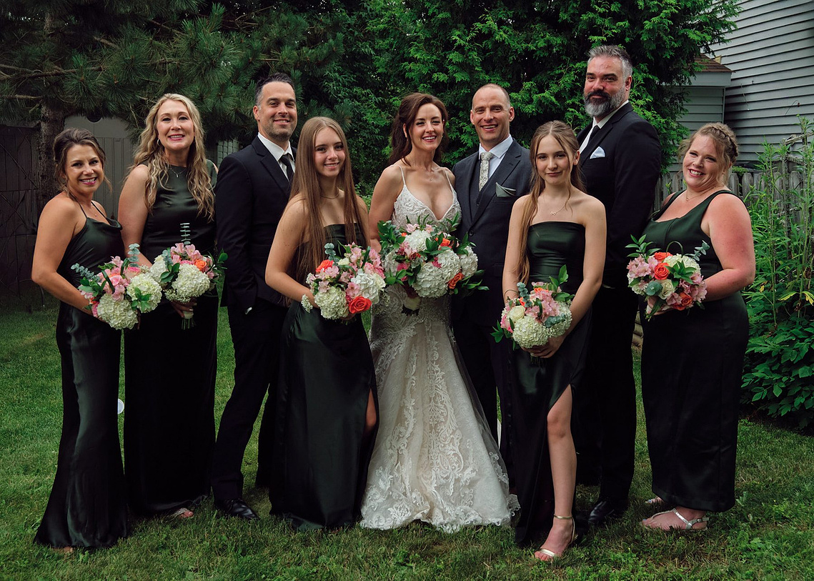 Bridal party photographed with visible motion blur during a short rain shower.