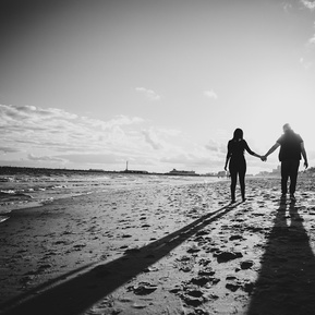 Couple walking in the beach during an engagement photo shoot in Melbourne