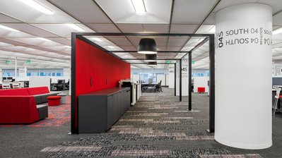 High-quality interior shot of a workplace breakout area with colorful modular seating, and flexible layouts designed for team interaction.