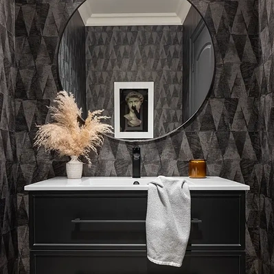 Luxury Airbnb interior photography of a powder room with black accents and modern art, exuding elegance and sophistication