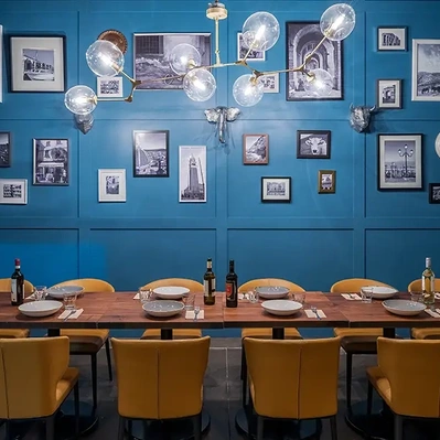 Hospitality interior photography showcasing a vibrant restaurant with blue paneled walls, creating a lively and inviting atmosphere.