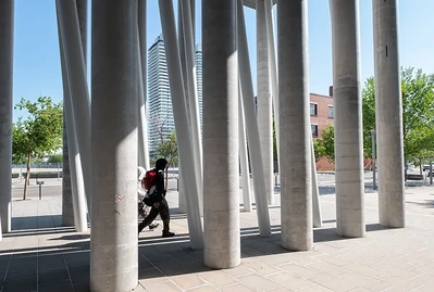 Person walking between columns
