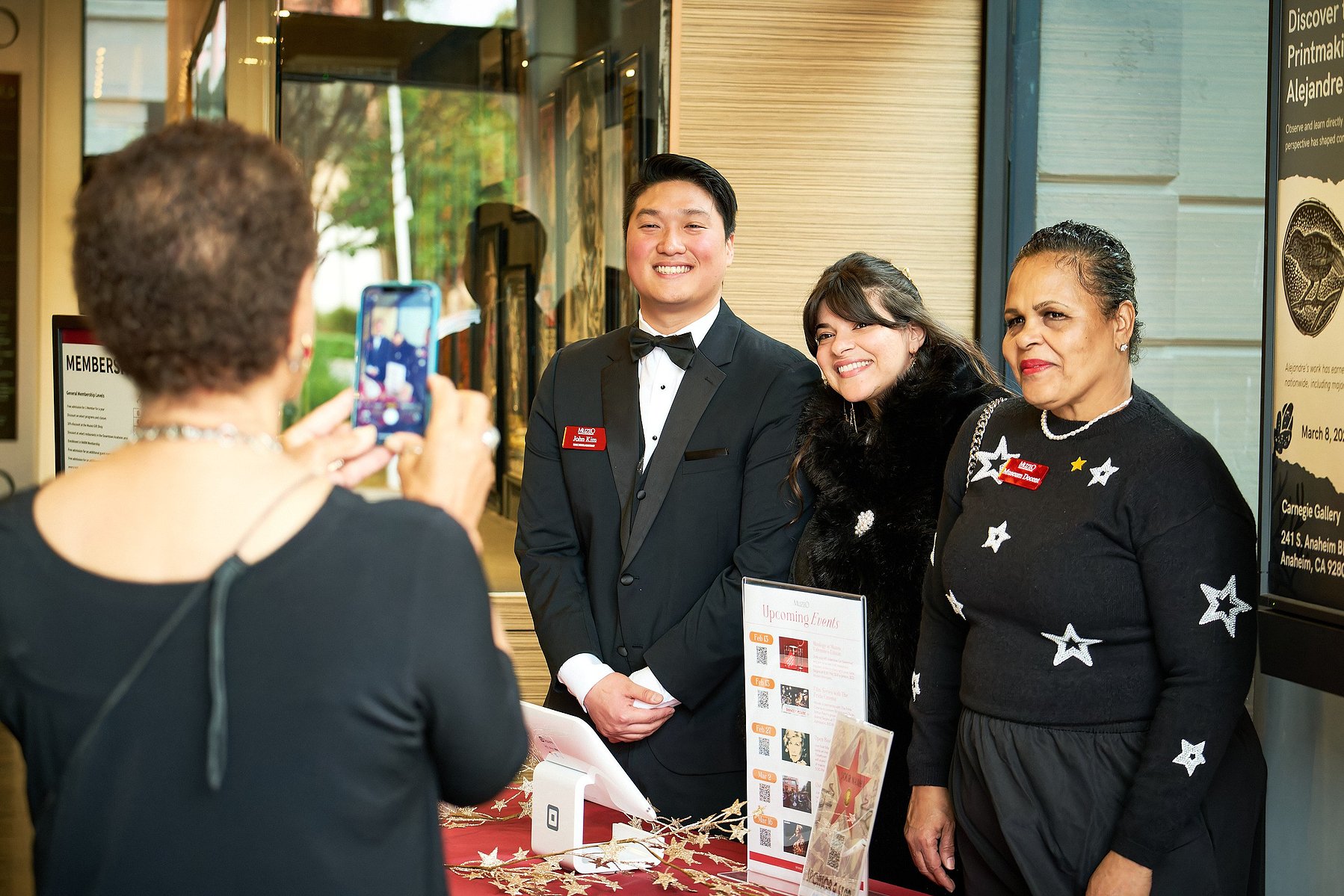 Muzeo staff pose for photo together dressed up in rental clothes from Friar Tux in Anaheim, CA