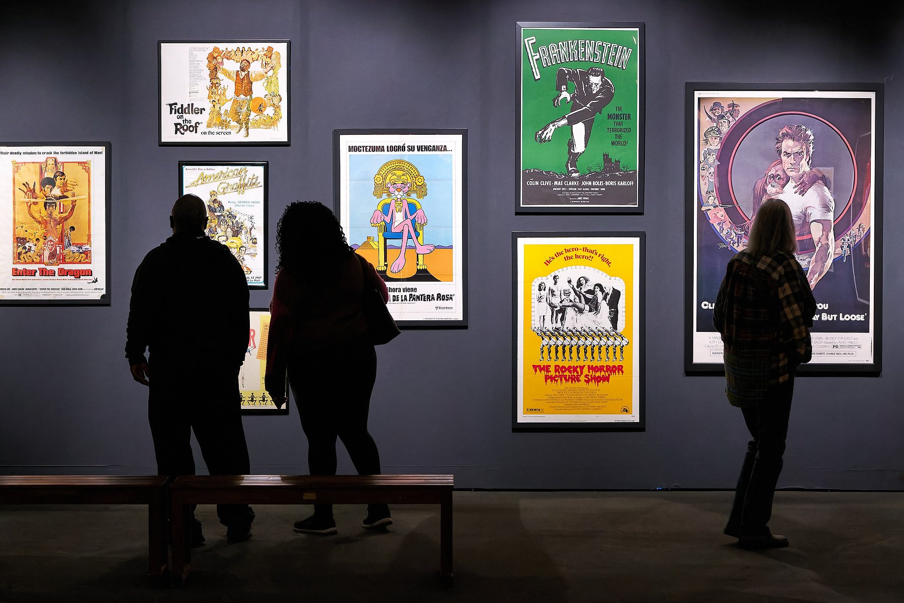 People stand and admire the posters at "Painted for the Pictures" at Muzeo in Anaheim, CA