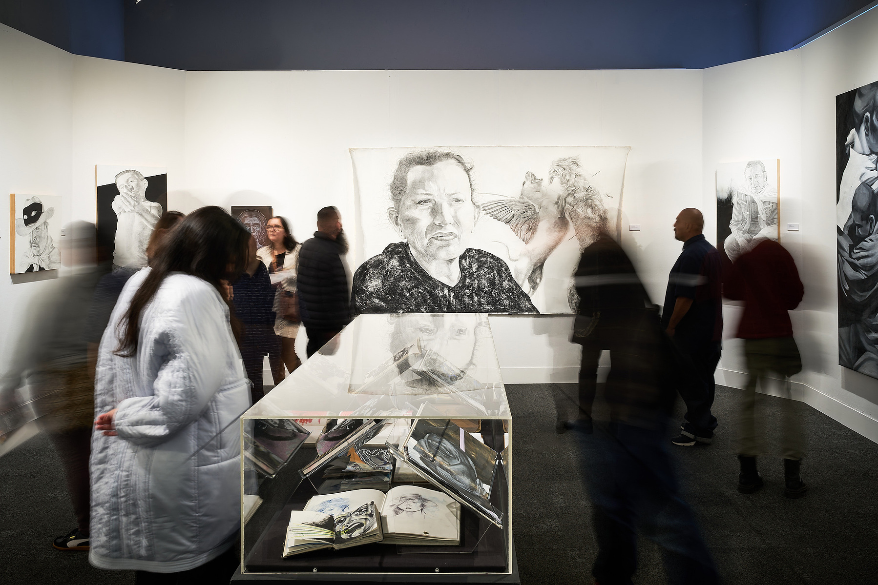 Long exposure photograph of guests admiring the artwork of Abel Alejandre at Muzeo, in Anaheim, CA.