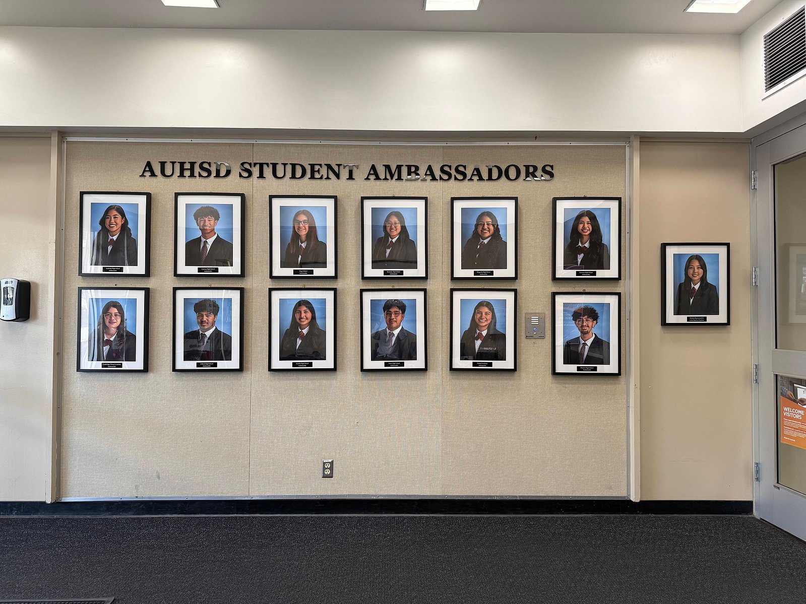 Framed headshots of the AUHSD student ambassadors from each of the high schools hangs in the foyer of the district office.