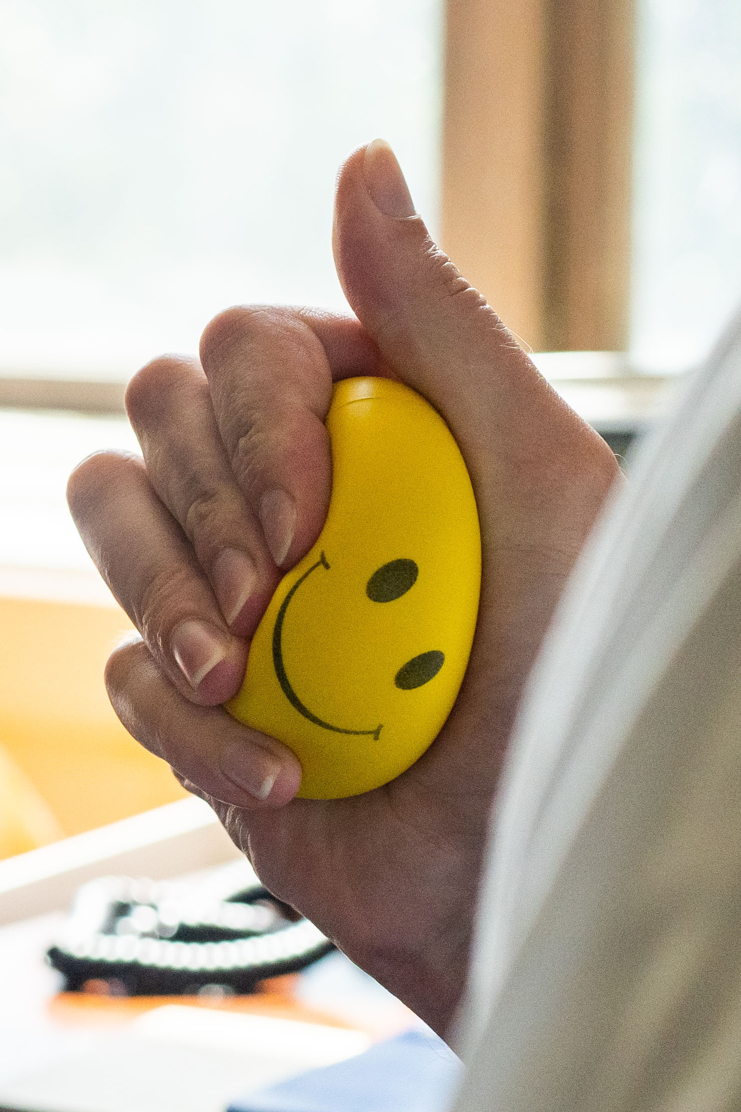 DC-Hill. A Senate staff squeezes a smiley stress ball as they prepare for the “vote a rama” of the Reconciliation bill on Saturday, August 6, 2022 (Photo by Haiyun Jiang/The New York Times)