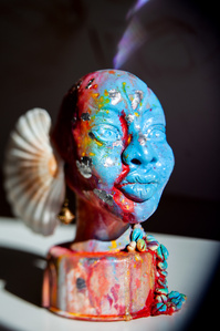 A blue decorative sculpture of a woman, portrait with seashells as ears made by artist Anrike Piel.