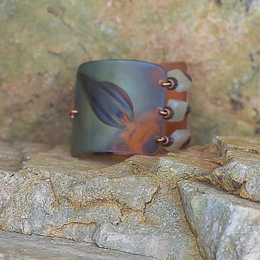 flame painted copper bracelet by sue priest shades of green blue and orange