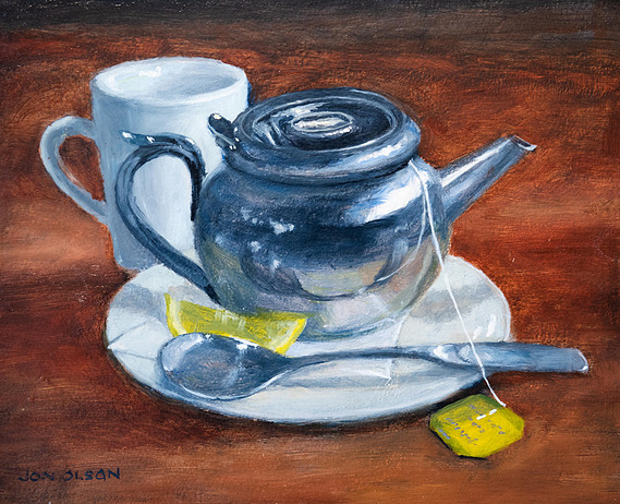 Silver tea pot with cup.