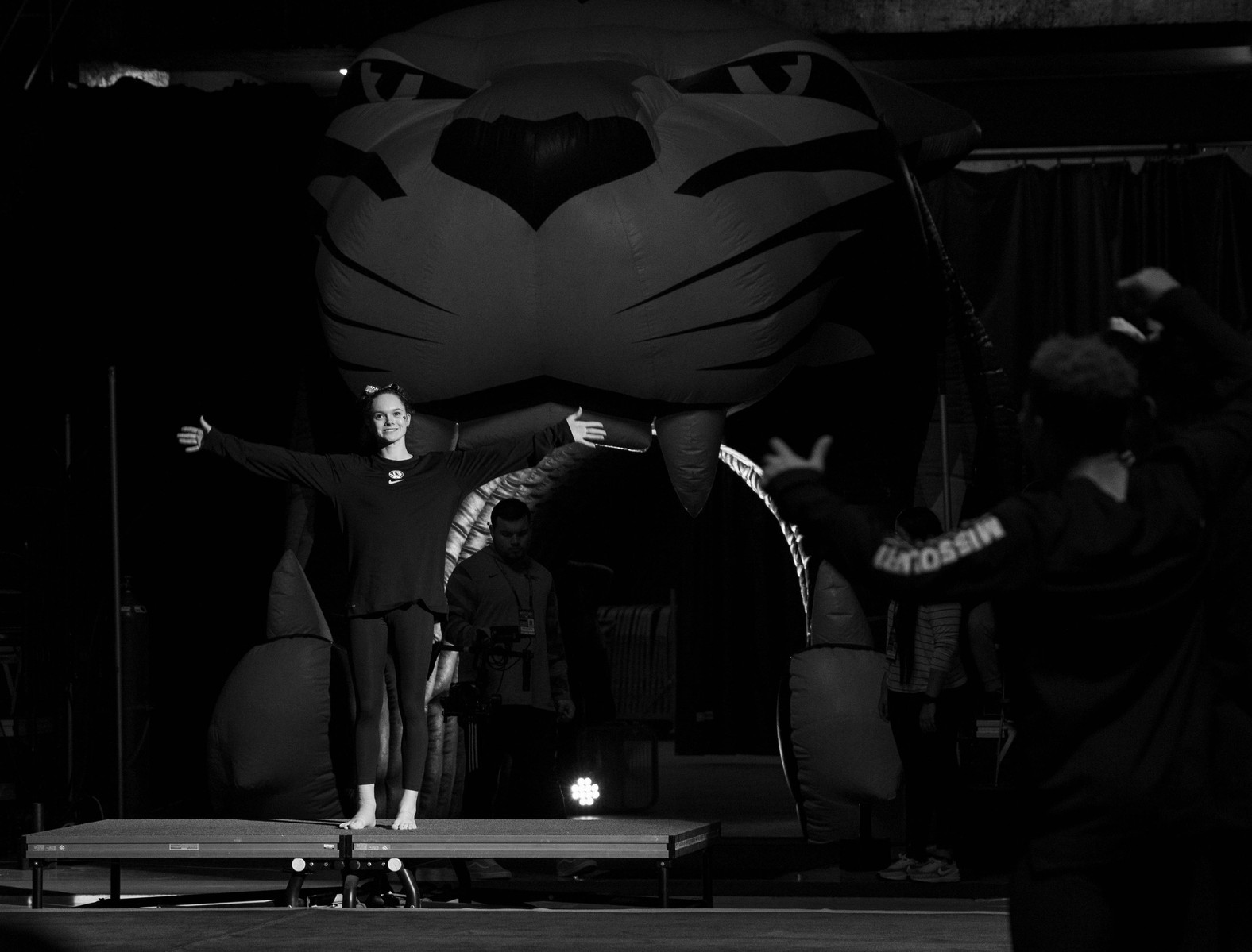 A gymnast stands in front of a crowd in a stadium. (Kate Trabalka Photography)