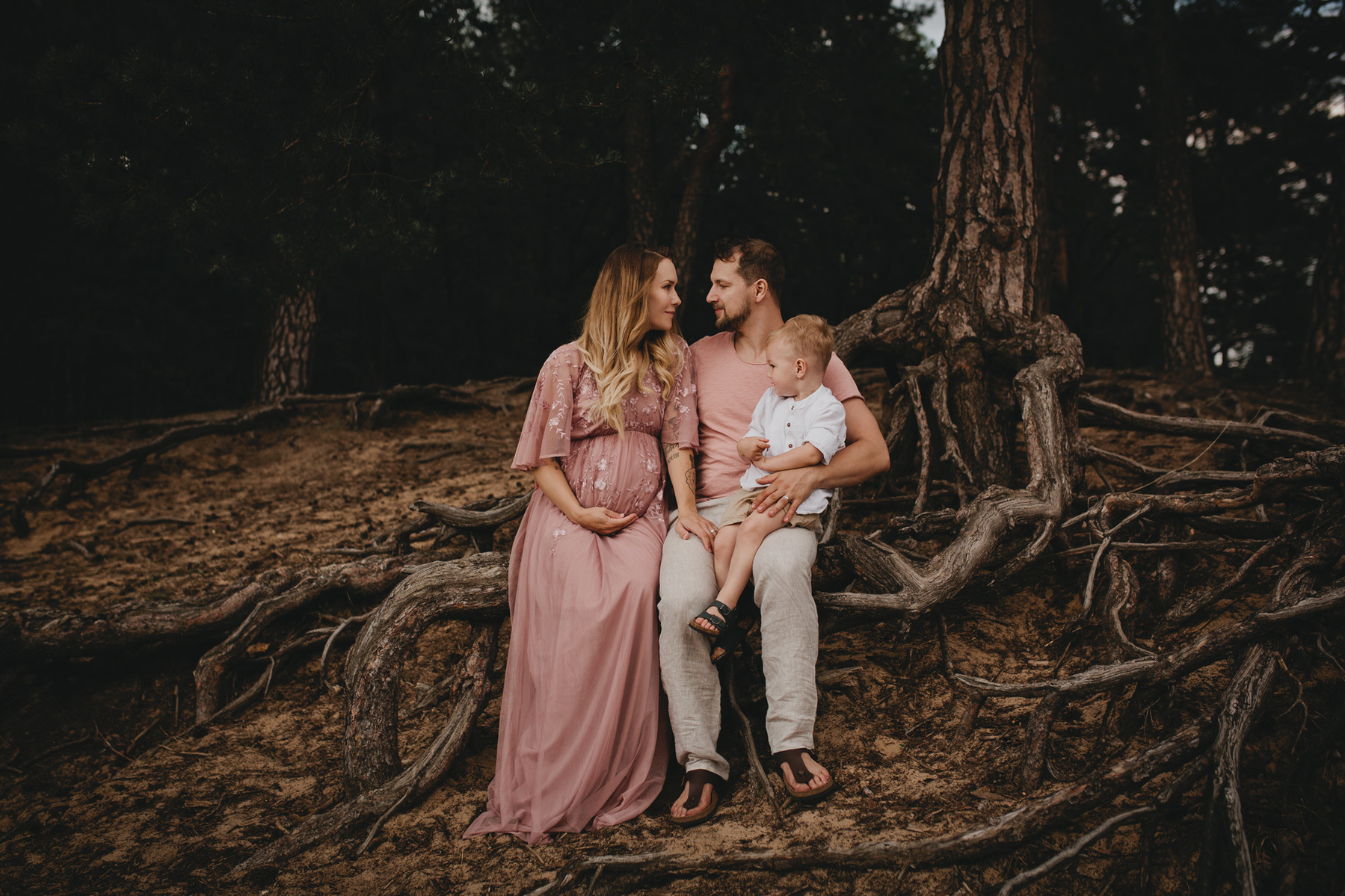 Familienfotos in der Natur mit Babybauch und abgestimmten Outfits in beige und rosé.