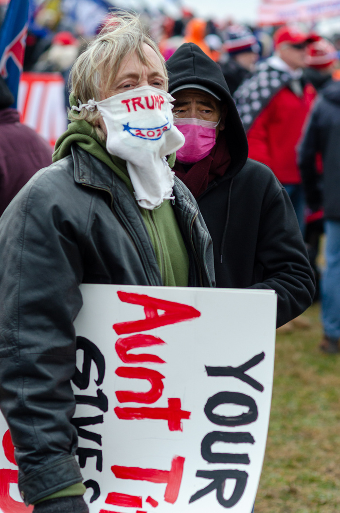 A man wearing Trump mask at a pro-Trump rally