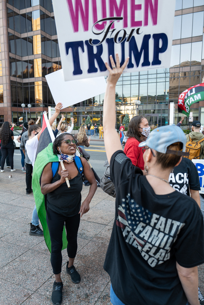 Black Lives Matter protester and a Trump supporter argue during the celebration of Biden victory in the 2020 United States presidential election