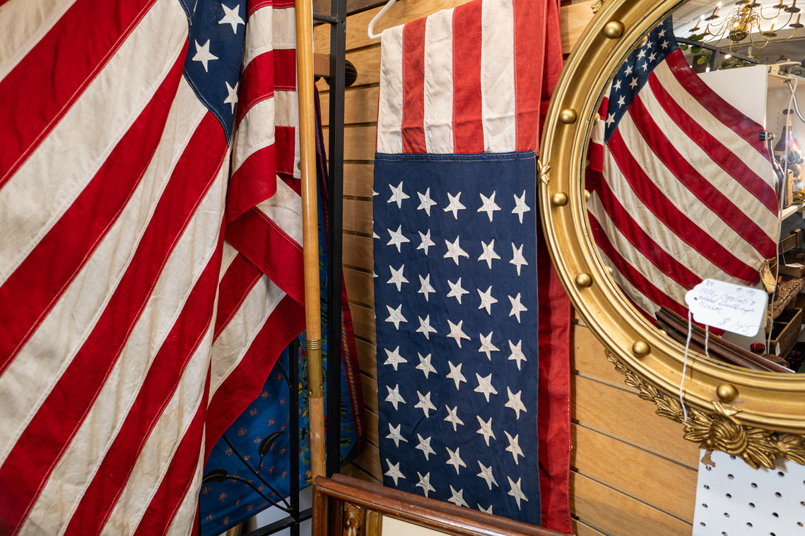 An old American flag and banner displayed in an antique shop, before the 2020 United States presidential election