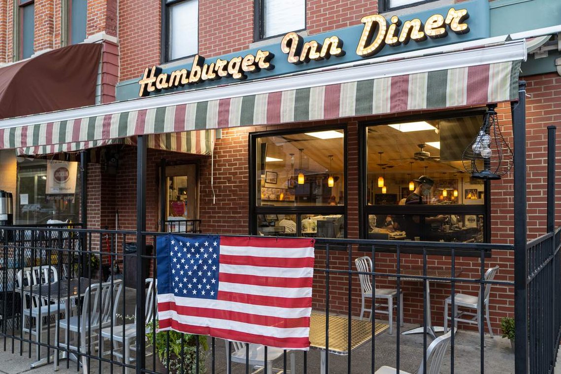 An American flag hanging on a patio of the local diner in a small town, before the 2020 United States presidential election