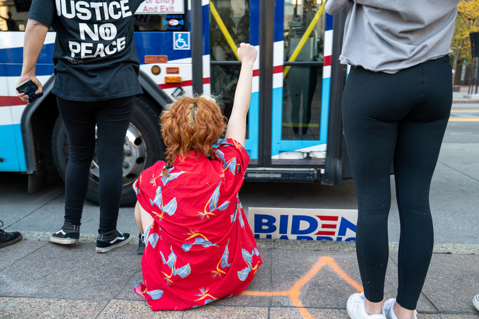 A red hair girl raising fist during the celebration of Biden victory in the 2020 United States presidential election