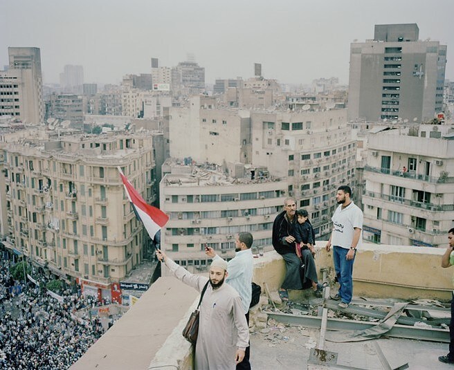 Name: Harry Mitchell Photograph Info: Men gather on a rooftop overlooking Tahrir Square during a large Friday demonstration, in which more than 100,000 people gathered to demonstrate against the incumbent military junta, Cairo, 2012 Image type: Digital C-