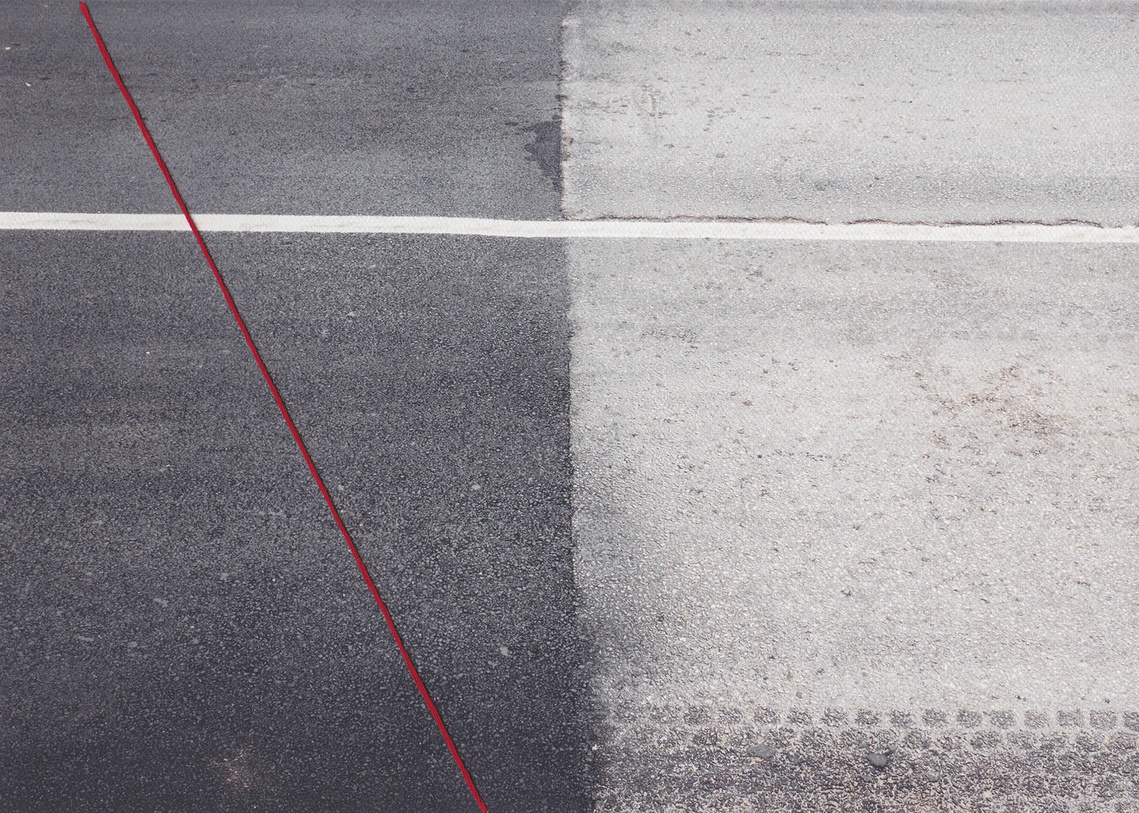Partially repaved road in Sarajevo showcases IEBL, dividing Bosnia and Herzegovina. Entities' lack of collaboration results in poor maintenance.